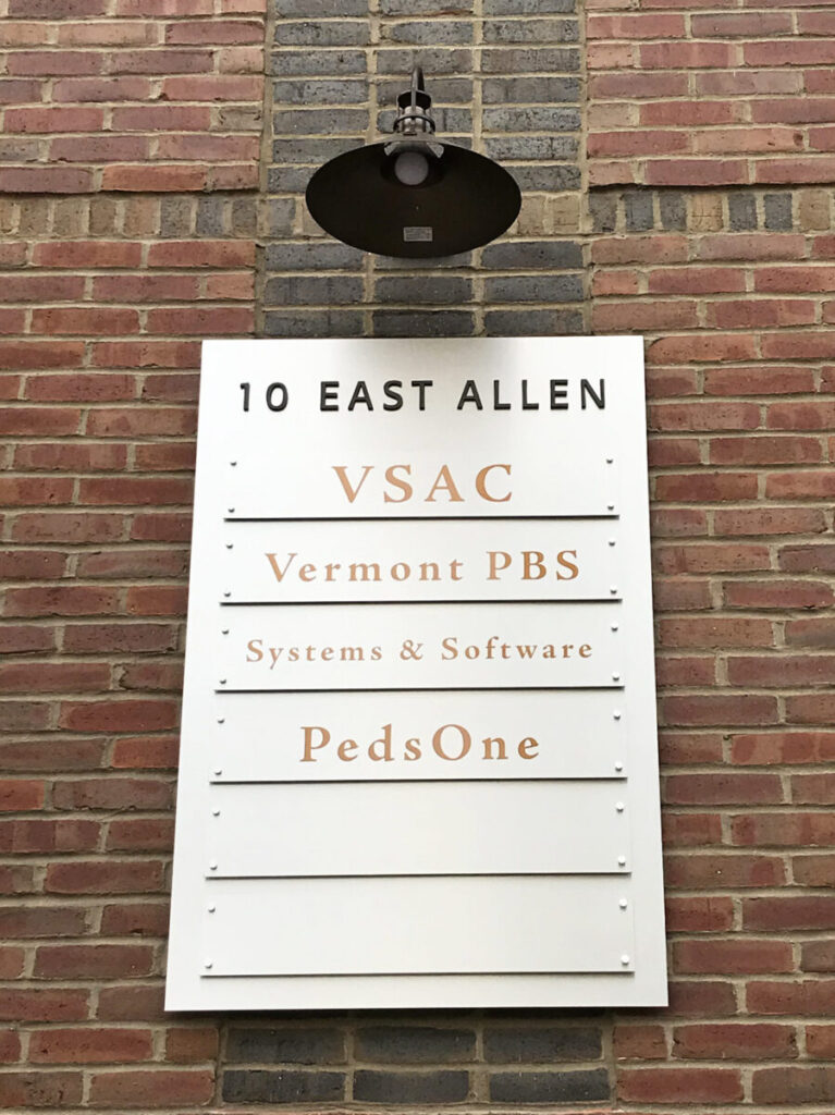 10 East Allen Directory A building directory sign lists VSAC, Vermont PBS, Systems & Software, and PedsOne at 10 East Allen.