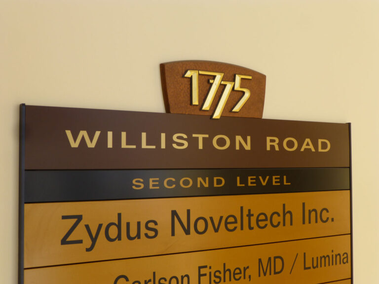 1775 Directory Detail Office directory sign showing "1775 Williston Road, Second Level, Zydus Noveltec Inc., Carlson Fisher, MD / Lumina.