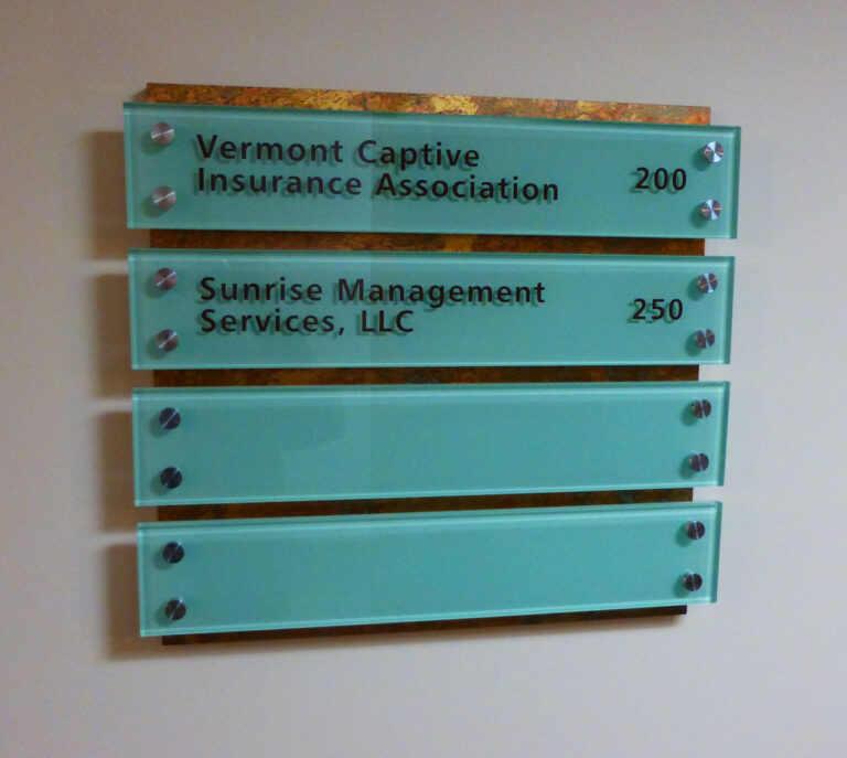 180 Battery Glass Door Sign Wall directory with listings for Vermont Captive Insurance Association in suite 200 and Sunrise Management Services in suite 250.