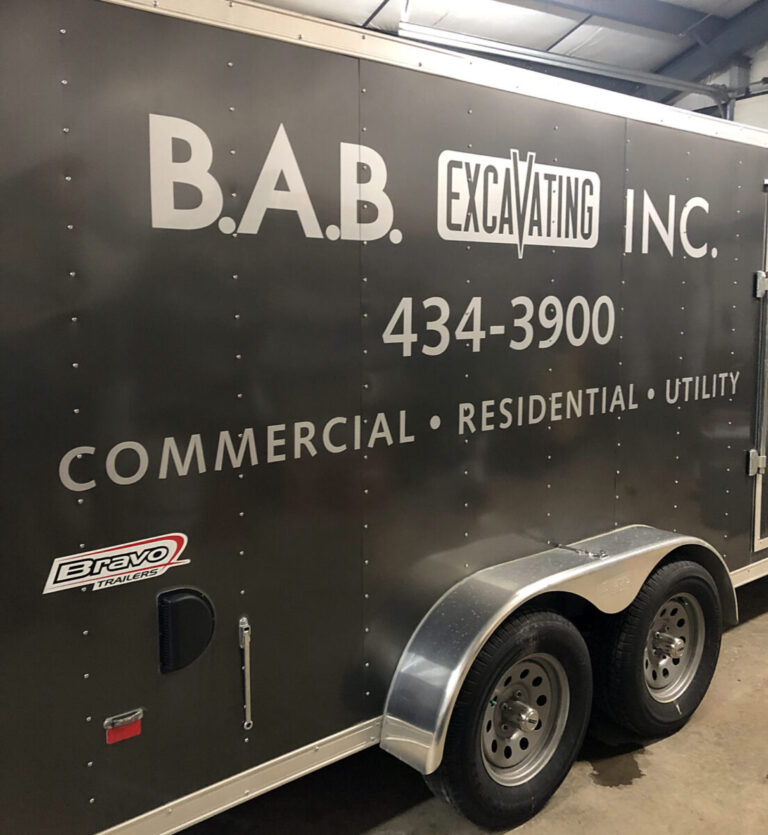 BAB Excavating Black trailer with B.A.B. Excavating Inc. logo, contact number, and service types: commercial, residential, utility.