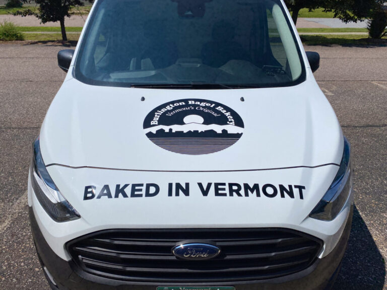 Burlington Bagel A white car with black and white logos on it.