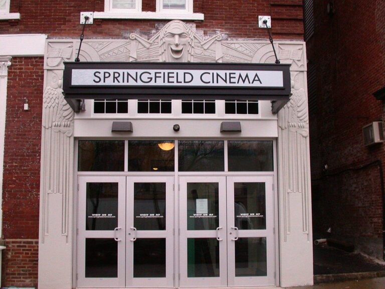Springfield Cinema Sign Entrance of Springfield Cinema with double glass doors and a white sign above, set in a red brick building.