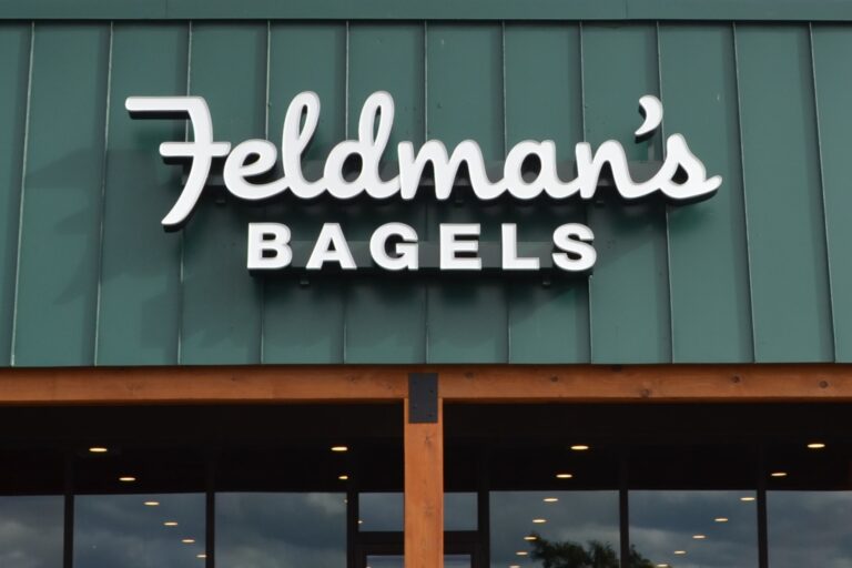 Feldman's Bagels Front view of a storefront with a sign reading "Feldman's Bagels" in white letters on a green background.