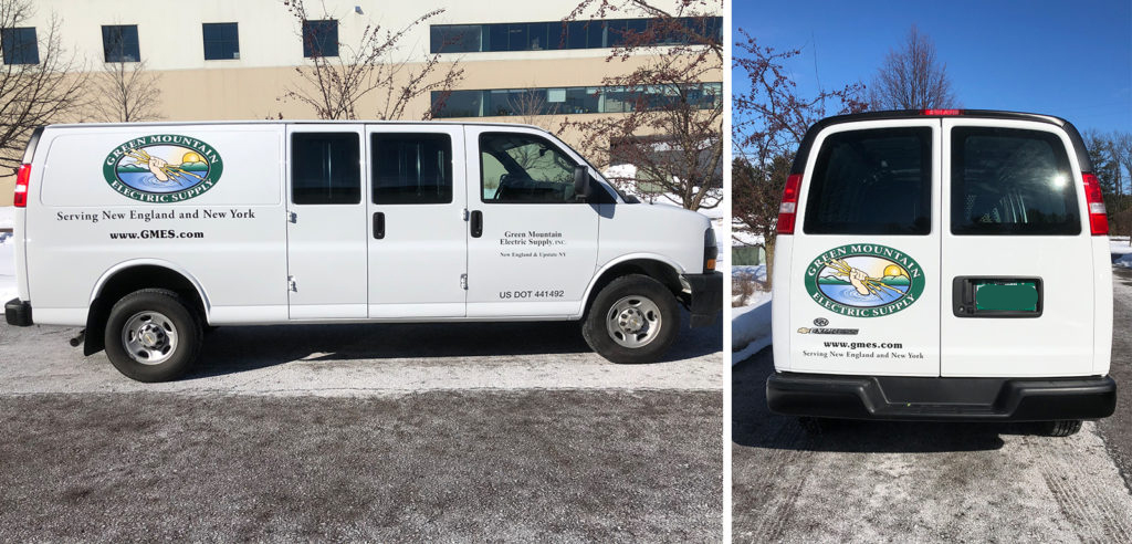 Green Mountain Electric Supply White van with Green Mountain Electric Supply logos and website, parked outdoors on a snowy surface, viewed from side and rear.