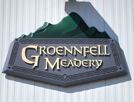 Groennfell Meadery Sign reading "Groennfell Meadery" with a mountain silhouette above, mounted on a white textured wall.