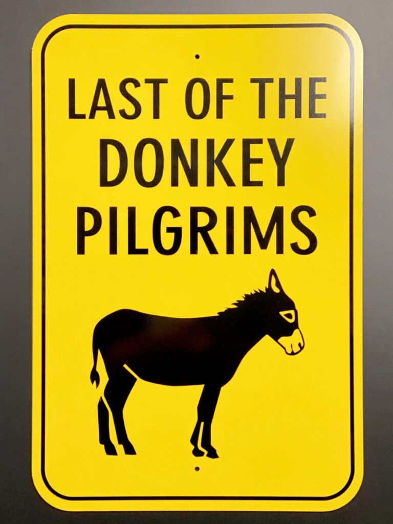 Custom Aluminum Parking Signs Yellow sign with bold text "LAST OF THE DONKEY PILGRIMS" above a simple silhouette of a donkey.