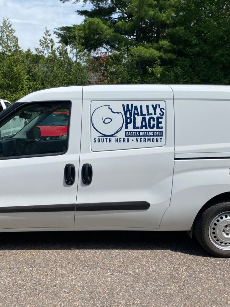 Wally's Place Van White van with "Wally's Place Bagels Breads Deli, South Hero, Vermont" logo and a bagel graphic on the side.
