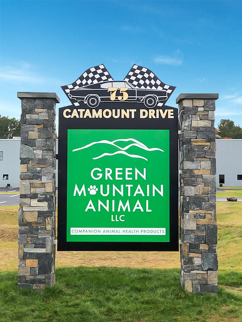 Green Mountain Animal Sign Stone sign for Green Mountain Animal LLC with address 75 Catamount Drive and checkered flag design on top.