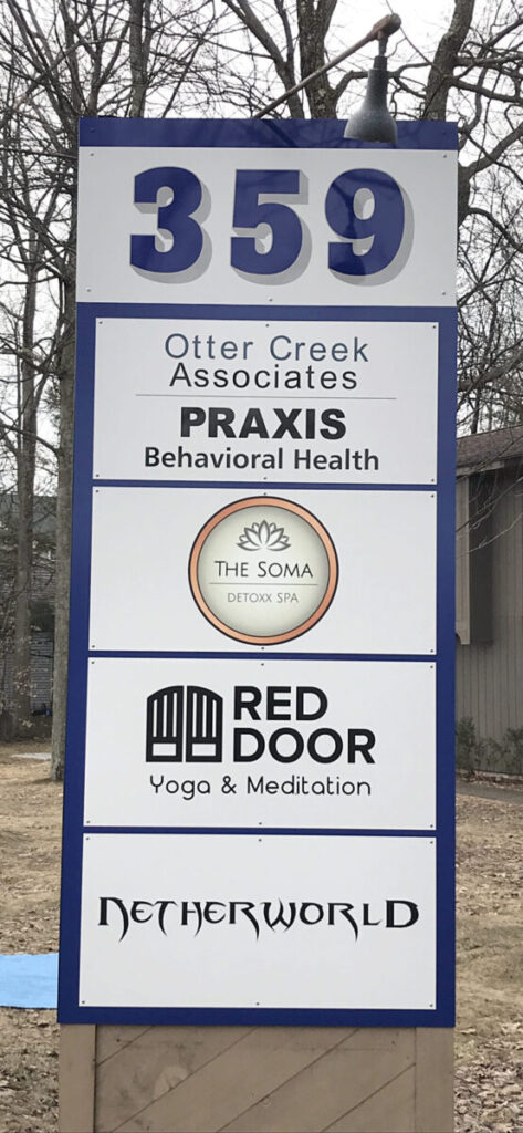 Aluminum Composite Sign A sign listing businesses at 359, including Otter Creek Associates, PRAXIS, The Soma, Red Door Yoga, and Netherworld.