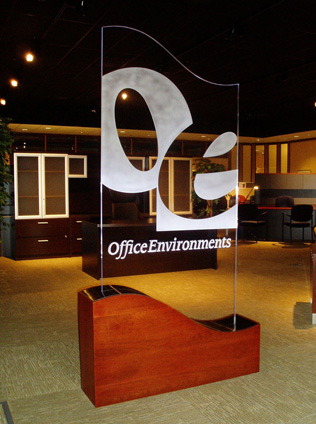 Office Environments Custom Led Sign A freestanding sign with "Office Environments" in an office showroom with desks and cabinets in the background.