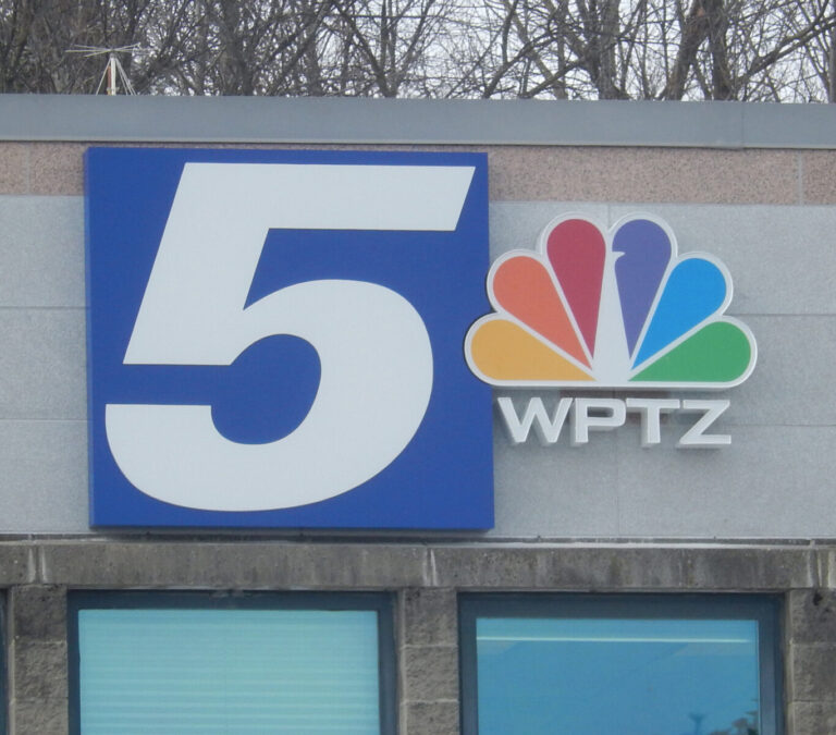 Logo Wall Sign with LED Lighting Sign on building showing NBC peacock logo, large number 5, and the call letters WPTZ.