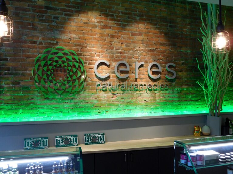 Ceres Sign Design Reception area of Ceres Natural Remedies with green lighting, brick wall, and product displays.