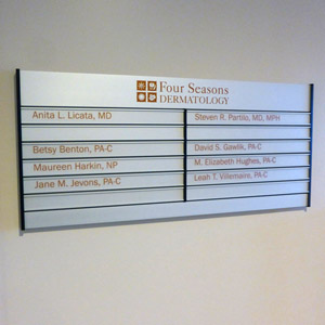 Four Seasons Directory Office directory sign for Four Seasons Dermatology listing names and titles of medical professionals.