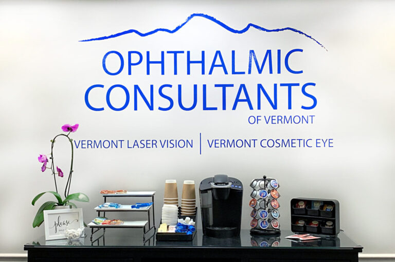 Vinyl Wall Lettering Reception area with coffee station and snacks beneath a wall sign reading "Ophthalmic Consultants of Vermont".